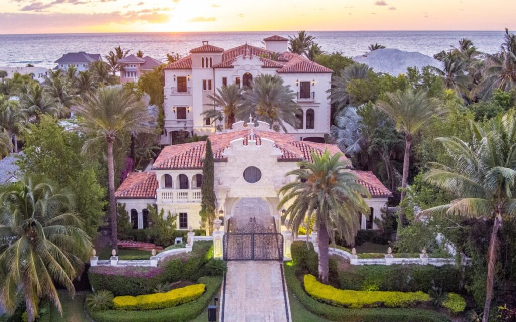 Aerial view of Palm Beach mansion and waterfront during sunset.